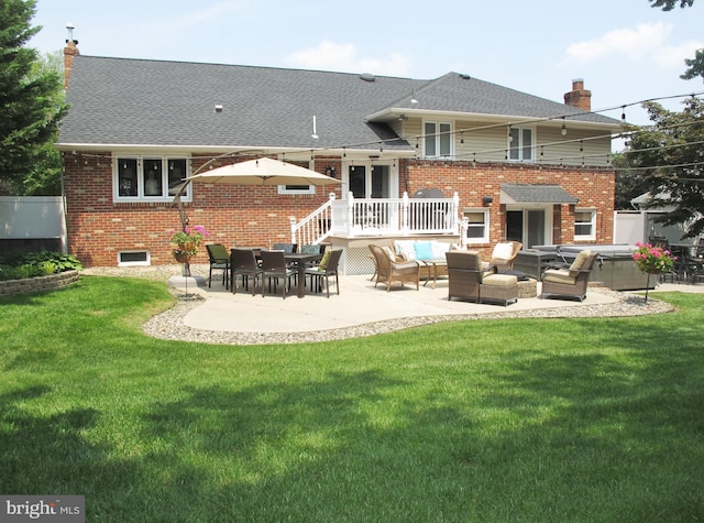 126 Devon Rd, Cinnaminson, NJ 08077 - rear view of house featuring a chimney, a patio area, a yard, and brick siding