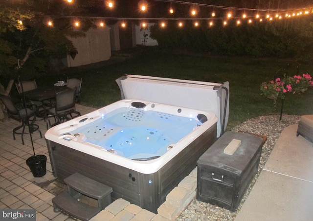 126 Devon Rd, Cinnaminson, NJ 08077 - patio at twilight featuring a hot tub, a patio, and a lawn