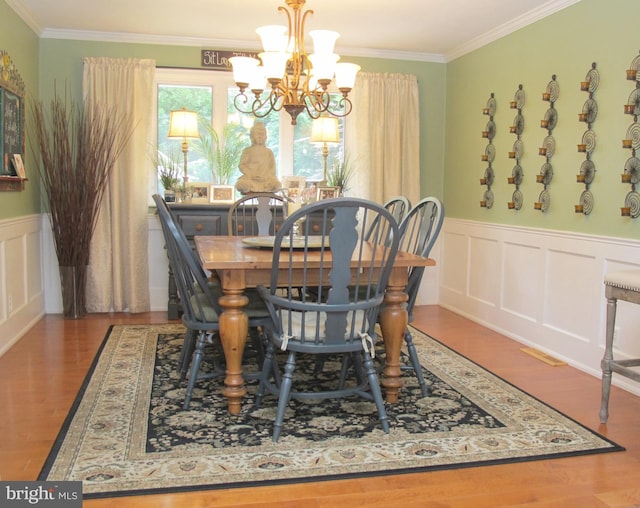 126 Devon Rd, Cinnaminson, NJ 08077 - dining space with a chandelier, crown molding, wood finished floors, wainscoting, and a decorative wall