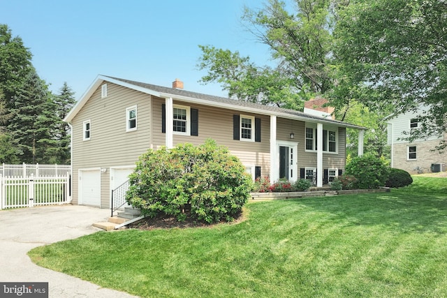 486 Highland Rd, Red Lion, PA 17356 - bi-level home with a chimney, concrete driveway, an attached garage, and cooling unit