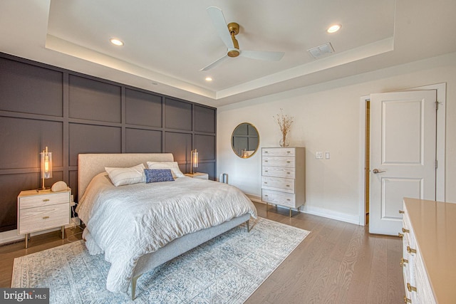 1001 Lakeview Ct Unit 1001, King Of Prussia, PA 19406 - bedroom with a raised ceiling, wood finished floors, recessed lighting, a ceiling fan, and a decorative wall