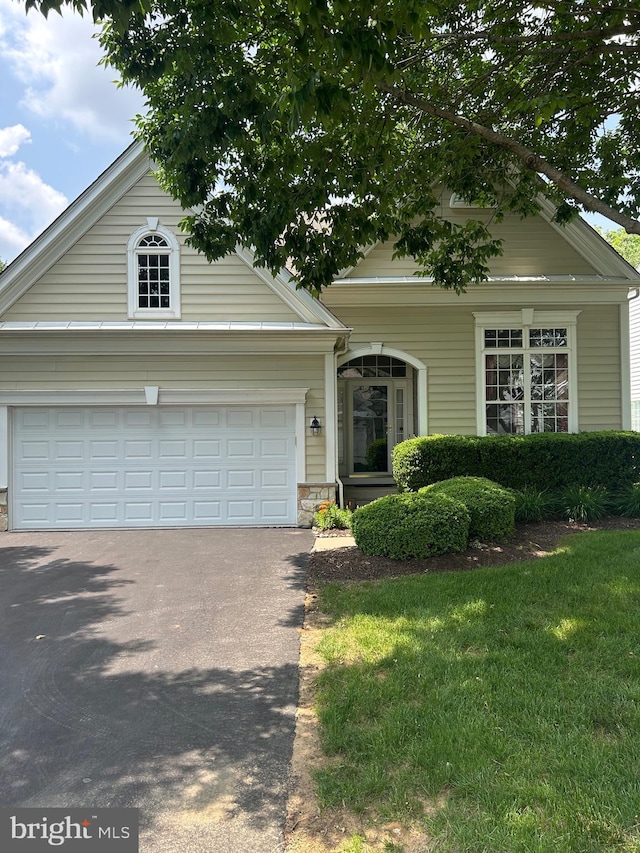 119 Violet Dr, Kennett Square, PA 19348 - view of front of property with driveway, a garage, a front yard, and stone siding