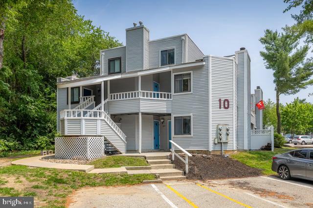 1004 Berwyck Ct, Sicklerville, NJ 08081 - view of property with a chimney, uncovered parking, stairs, and covered porch