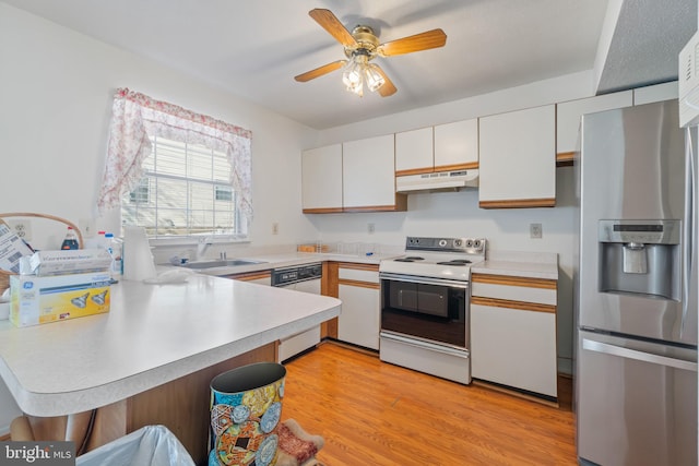 8078 Outing Ave, Pasadena, MD 21122 - kitchen with white appliances, under cabinet range hood, a peninsula, and light countertops