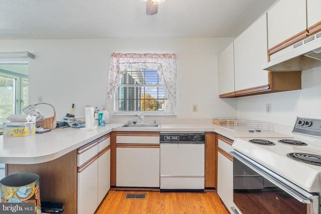8078 Outing Ave, Pasadena, MD 21122 - kitchen featuring white appliances, a sink, under cabinet range hood, a peninsula, and light countertops