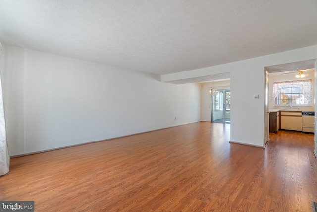 8078 Outing Ave, Pasadena, MD 21122 - unfurnished living room featuring wood finished floors and a sink