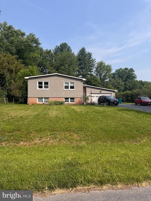 10694 Salem Ave, Thurmont, MD 21788 - tri-level home featuring a front yard, brick siding, driveway, and an attached garage