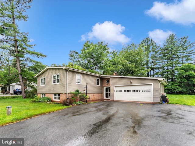 10694 Salem Ave, Thurmont, MD 21788 - view of front of house with a garage, driveway, a front yard, a chimney, and brick siding