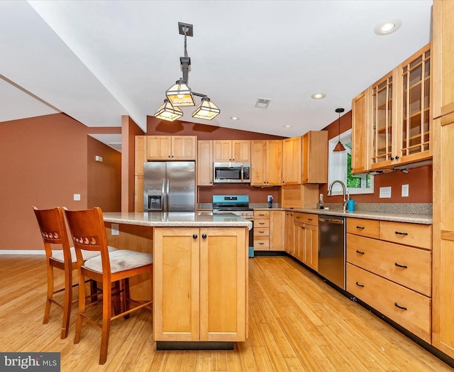 10694 Salem Ave, Thurmont, MD 21788 - kitchen with appliances with stainless steel finishes, light brown cabinets, a breakfast bar, light wood-style floors, and a center island