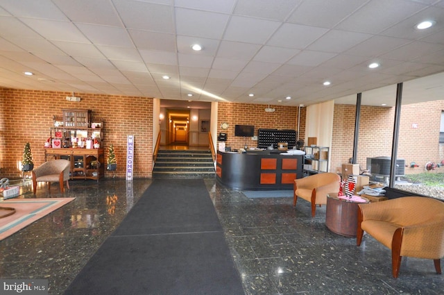 6317 Park Heights Ave Unit 310, Baltimore, MD 21215 - reception featuring a paneled ceiling, recessed lighting, and brick wall