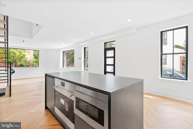 2301 Naudain St, Philadelphia, PA 19146 - kitchen featuring appliances with stainless steel finishes, dark countertops, a kitchen island, baseboards, and recessed lighting