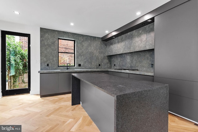 2301 Naudain St, Philadelphia, PA 19146 - kitchen featuring modern cabinets, gas cooktop, a kitchen island, backsplash, and recessed lighting