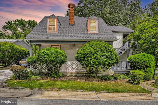 133 S Prospect Ave, Baltimore, MD 21228 - new england style home featuring a chimney, roof with shingles, and a garage