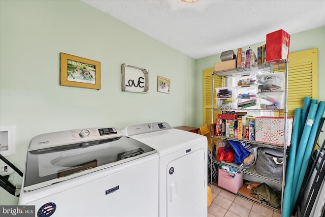 133 S Prospect Ave, Baltimore, MD 21228 - laundry area featuring washing machine and dryer, light tile patterned floors, and a textured ceiling