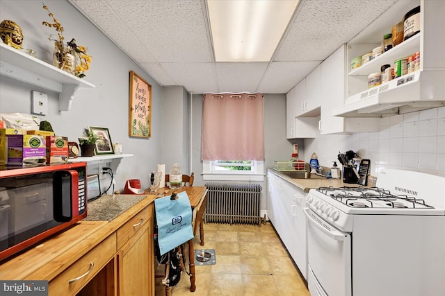 133 S Prospect Ave, Baltimore, MD 21228 - kitchen featuring gas range gas stove, open shelves, radiator heating unit, a paneled ceiling, and black microwave