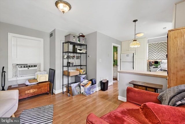 133 S Prospect Ave, Baltimore, MD 21228 - living area with cooling unit, light wood-type flooring, and baseboards
