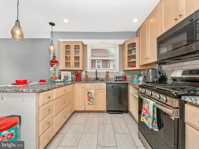 3812 Callaway Ave, Baltimore, MD 21215 - kitchen with stainless steel range with gas stovetop, dishwashing machine, black microwave, light brown cabinets, and a sink