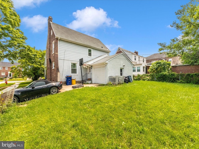 3812 Callaway Ave, Baltimore, MD 21215 - rear view of house featuring an attached garage, a chimney, and a yard