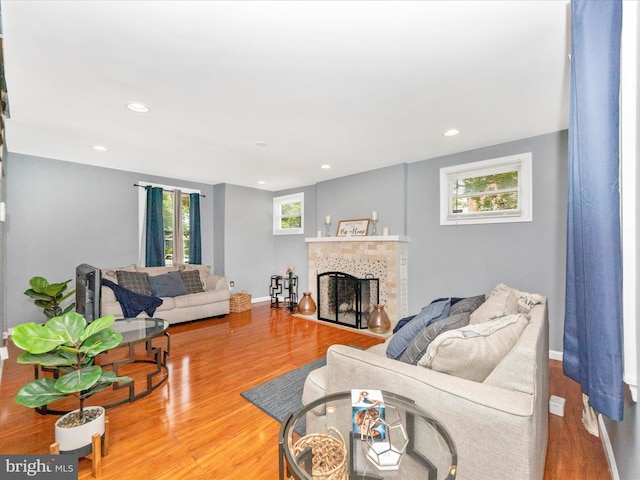 3812 Callaway Ave, Baltimore, MD 21215 - living area featuring wood finished floors, a fireplace, recessed lighting, and baseboards