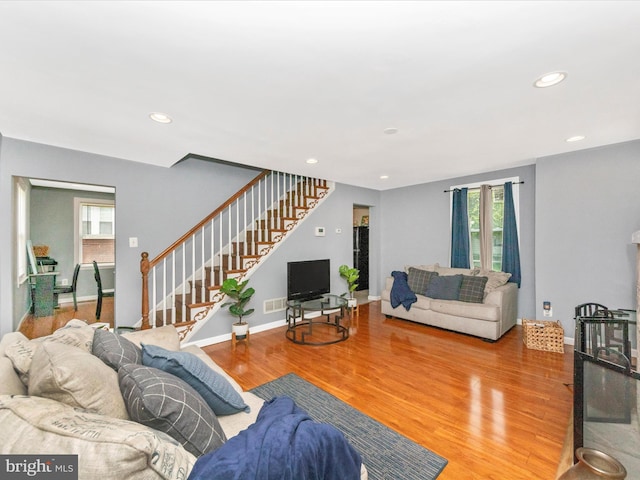 3812 Callaway Ave, Baltimore, MD 21215 - living area with stairway, wood finished floors, recessed lighting, and baseboards