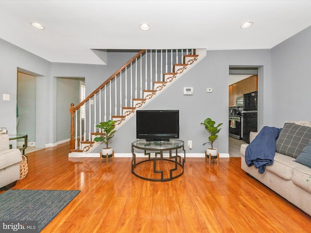 3812 Callaway Ave, Baltimore, MD 21215 - living room featuring wood finished floors, stairs, recessed lighting, and baseboards