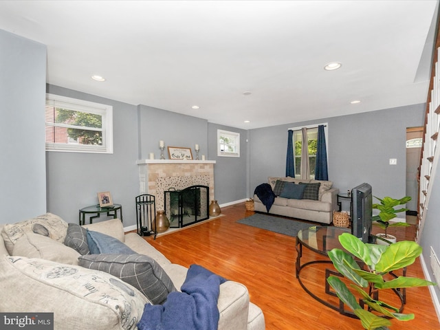 3812 Callaway Ave, Baltimore, MD 21215 - living room featuring a tile fireplace, recessed lighting, baseboards, and wood finished floors