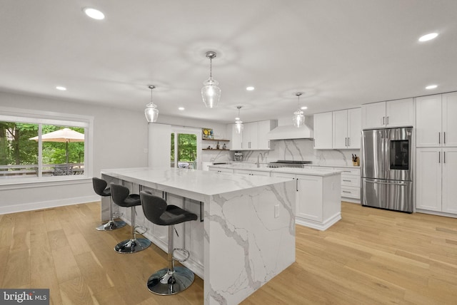 7816 Wendy Ridge Ln, Annandale, VA 22003 - kitchen with smart refrigerator, a spacious island, recessed lighting, light wood-type flooring, and white cabinetry