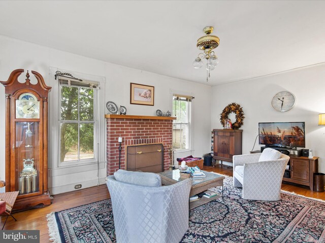 140 Delaware Ave, Laurel, DE 19956 - living area with healthy amount of natural light, a fireplace, and wood finished floors