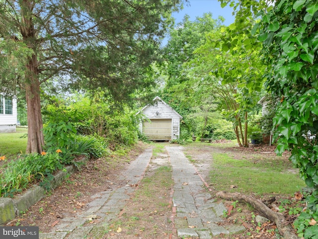 140 Delaware Ave, Laurel, DE 19956 - view of yard with dirt driveway, an outdoor structure, and a garage