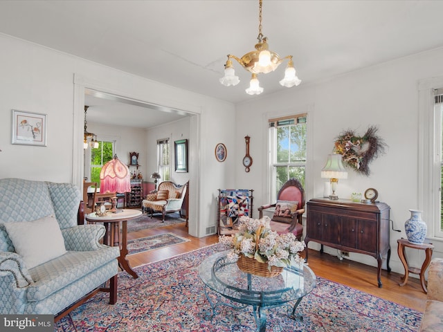 140 Delaware Ave, Laurel, DE 19956 - living area with a chandelier, healthy amount of natural light, wood finished floors, and ornamental molding