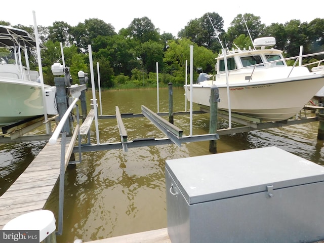 215 Cedar Beach Dr, Prince Frederick, MD 20678 - dock with boat lift, a water view, and view of scattered trees