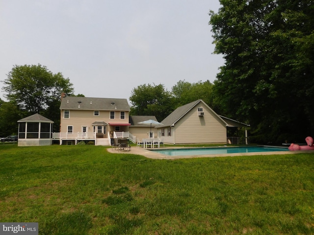 215 Cedar Beach Dr, Prince Frederick, MD 20678 - back of house featuring an outdoor pool, a deck, a yard, and a sunroom