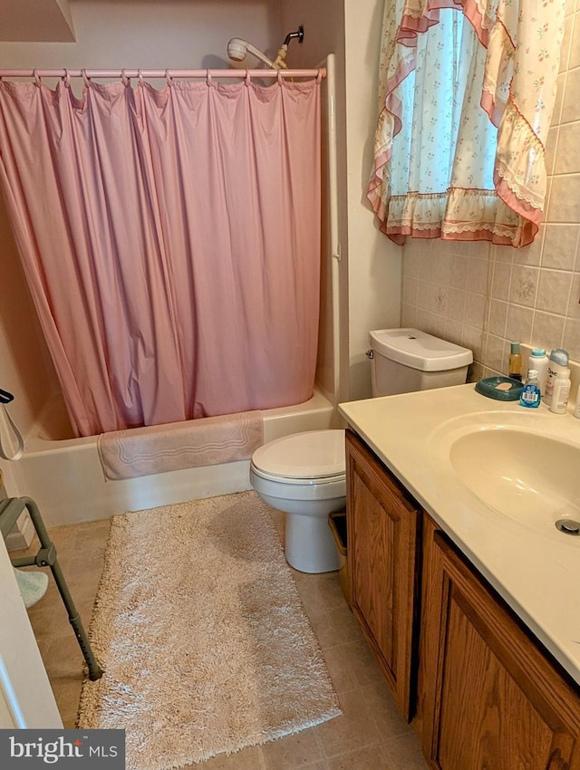 9933 Hoovers Hill Rd, Huntingdon, PA 16652 - full bath with shower / bath combo with shower curtain, vanity, tile walls, backsplash, and tile patterned flooring