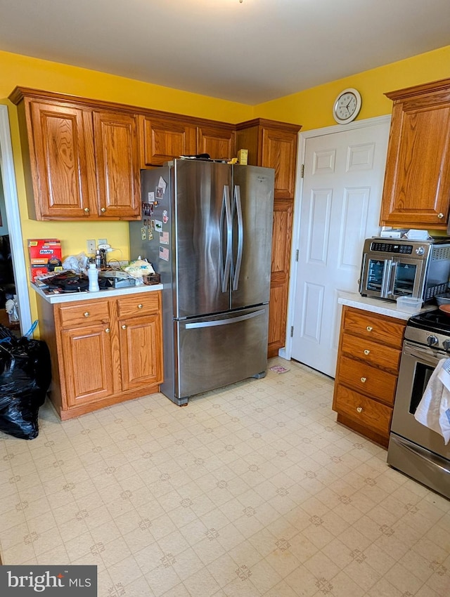 9933 Hoovers Hill Rd, Huntingdon, PA 16652 - kitchen featuring stainless steel appliances, light countertops, light flooring, and brown cabinetry