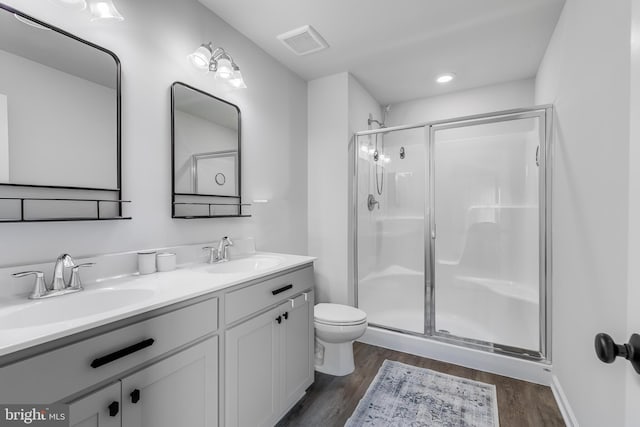 9307 Cedar Forest Dr, Fredericksburg, VA 22408 - bathroom with a shower stall, wood finished floors, and double vanity