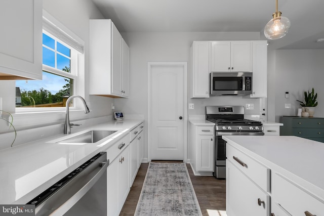 9307 Cedar Forest Dr, Fredericksburg, VA 22408 - kitchen featuring appliances with stainless steel finishes, white cabinetry, dark wood finished floors, and light countertops