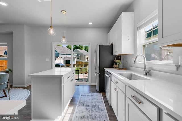 9307 Cedar Forest Dr, Fredericksburg, VA 22408 - kitchen featuring stainless steel appliances, a kitchen island, light countertops, white cabinetry, and dark wood-style floors
