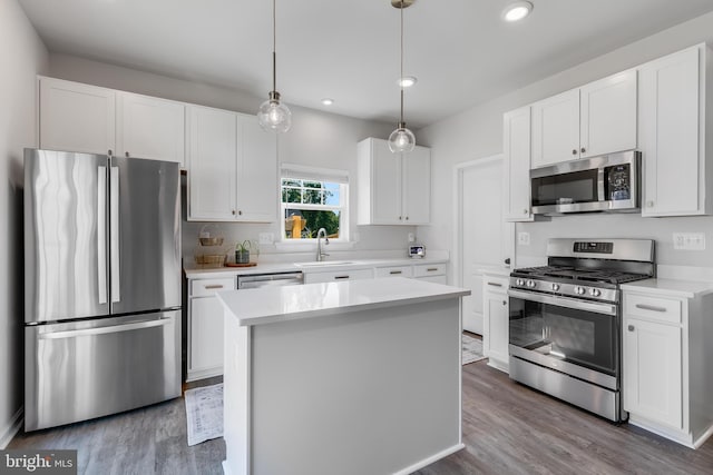 9307 Cedar Forest Dr, Fredericksburg, VA 22408 - kitchen with stainless steel appliances, wood finished floors, white cabinets, light countertops, and recessed lighting