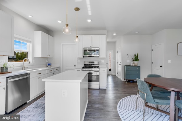 9307 Cedar Forest Dr, Fredericksburg, VA 22408 - kitchen featuring stainless steel appliances, recessed lighting, light countertops, white cabinetry, and a kitchen island