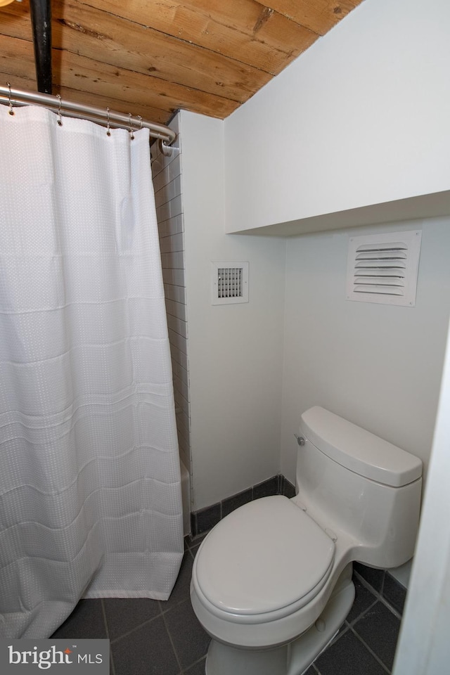 309 Arch St Unit 301, Philadelphia, PA 19106 - bathroom with tile patterned floors, toilet, wood ceiling, and shower / bath combination with curtain