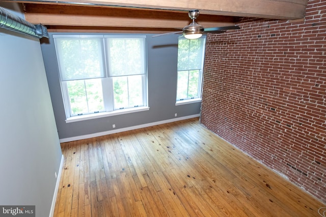 309 Arch St Unit 301, Philadelphia, PA 19106 - spare room featuring baseboards, a ceiling fan, hardwood / wood-style floors, beamed ceiling, and brick wall
