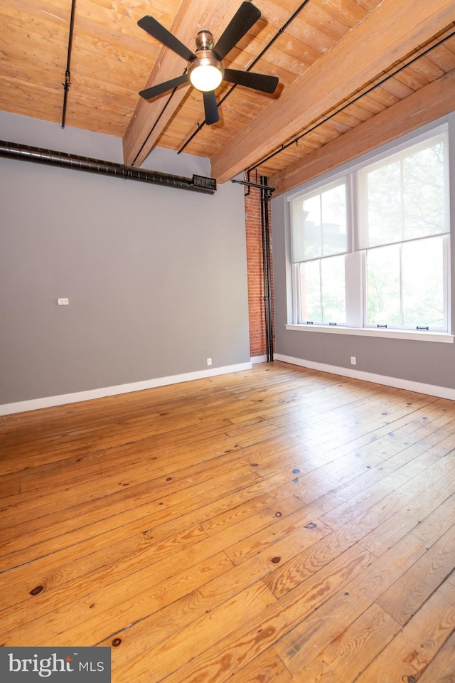 309 Arch St Unit 301, Philadelphia, PA 19106 - unfurnished room with wooden ceiling with exposed beams, baseboards, hardwood / wood-style flooring, a ceiling fan, and a barn door