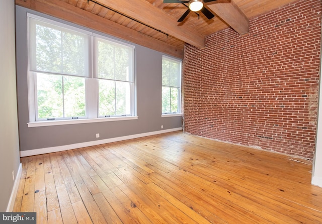 309 Arch St Unit 301, Philadelphia, PA 19106 - empty room featuring brick wall, wood ceiling with exposed beams, healthy amount of natural light, a ceiling fan, and baseboards