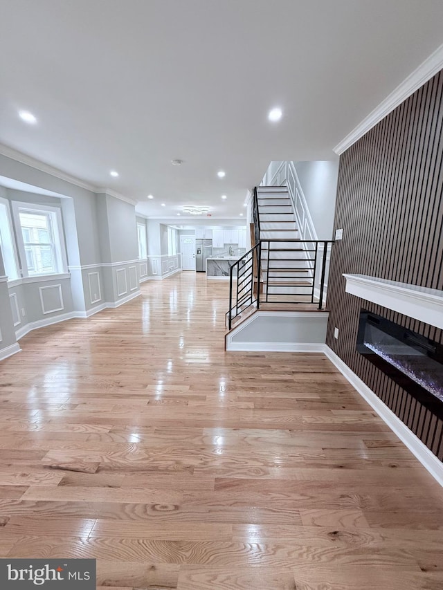 56 E Tulpehocken St, Philadelphia, PA 19144 - unfurnished living room featuring stairway, wood finished floors, ornamental molding, a glass covered fireplace, and recessed lighting