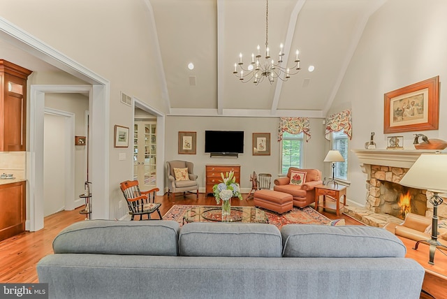 217 Valley Ridge Rd, Haverford, PA 19041 - living area featuring light wood-style floors, a chandelier, high vaulted ceiling, a fireplace, and beam ceiling