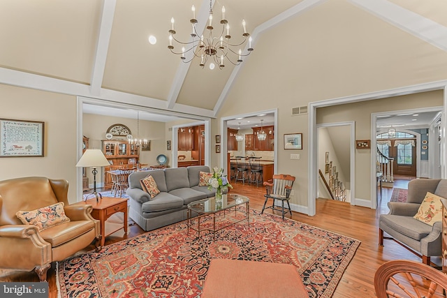 217 Valley Ridge Rd, Haverford, PA 19041 - living room with a chandelier, light wood finished floors, high vaulted ceiling, stairs, and beam ceiling