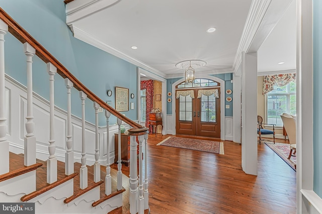 217 Valley Ridge Rd, Haverford, PA 19041 - foyer entrance featuring ornamental molding, a decorative wall, a chandelier, wood finished floors, and stairs