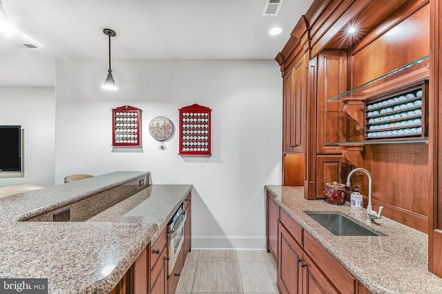 217 Valley Ridge Rd, Haverford, PA 19041 - kitchen with light stone countertops, hanging light fixtures, brown cabinets, and recessed lighting