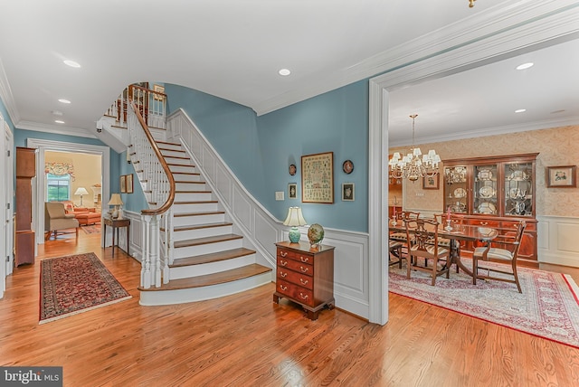 217 Valley Ridge Rd, Haverford, PA 19041 - stairway featuring wood finished floors, a wainscoted wall, a chandelier, crown molding, and recessed lighting