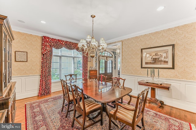 217 Valley Ridge Rd, Haverford, PA 19041 - dining space with a chandelier, wallpapered walls, crown molding, light wood-style flooring, and wainscoting